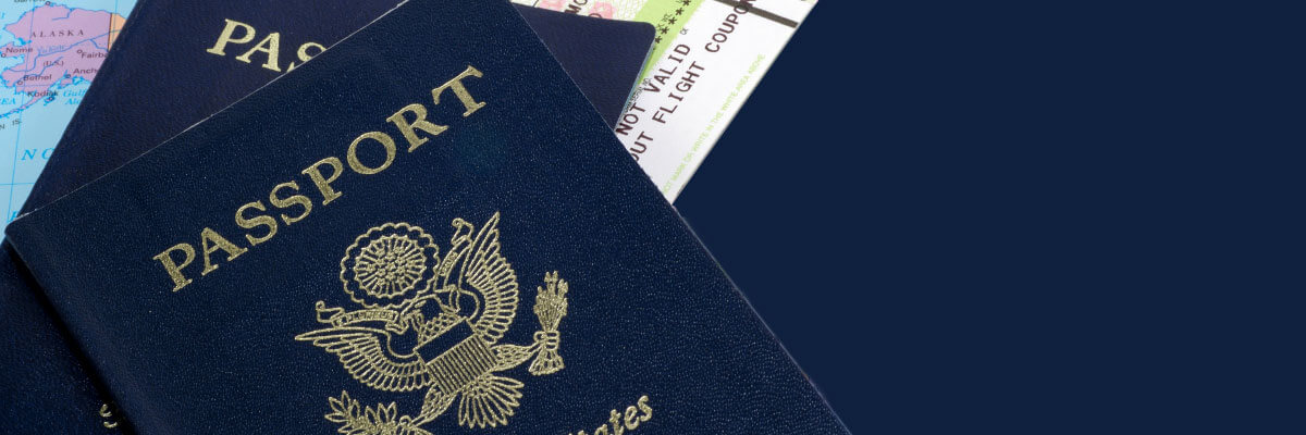 Two passports on top of a map and plane ticket